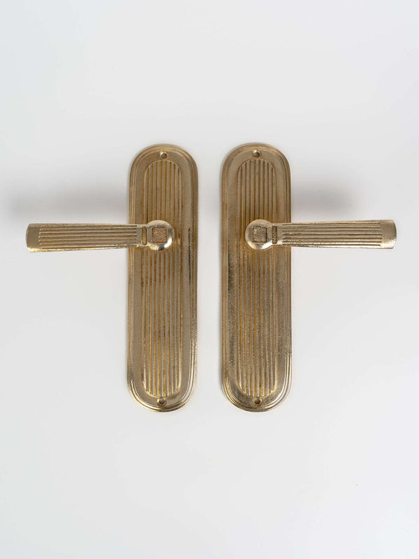 A large left and right view of a brass finish passage door lever set